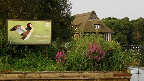 A view of the floating visitor centre and Ranworth signage from the water.