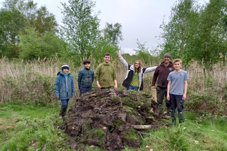 A group of young wilder wardens posing with their hibernaculum