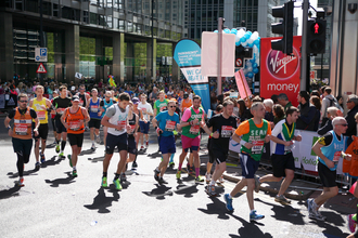 Runners on a sunday day in Canary Wharf as part of the London Marathon