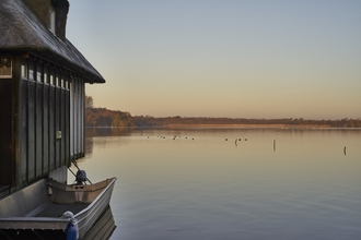 A view across Ranworth Broad at sunset, beside the visitor centre
