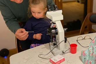 NWT Reserves Officer Robert Morgan and his granddaughter play with a microscope