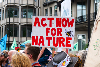 A placard at a march in London that says 'Act for nature'