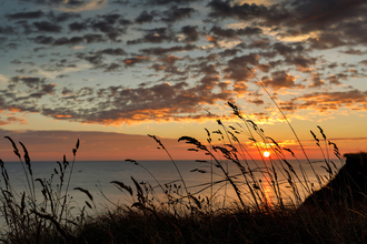 Sunrise over dunes along the Norfolk Norfolk coast.