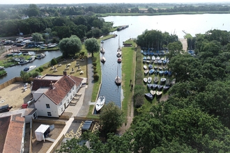 Aerial view of the Pleasure Boat Inn with views of Hickling Staithe and the wider broad