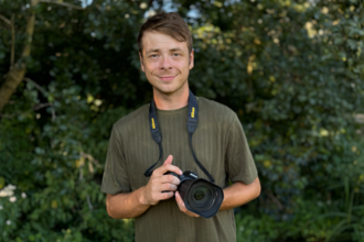 Alfie Bowen smiling with his camera