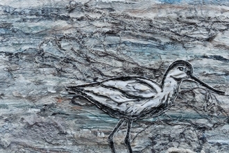 Textile image of an avocet on the shoreline