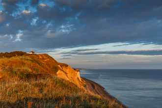 Cliffs, cloudy skies and blue sea.