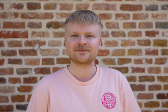 Picture of James McDermott with a brick wall background