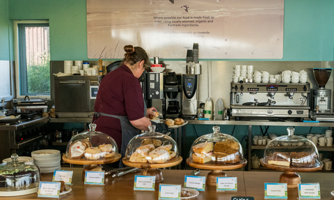Member of staff working in the cafe at NWT Cley Marshes visitor centre