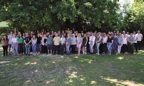A group photo of all the NWT staff outside on a sunny day