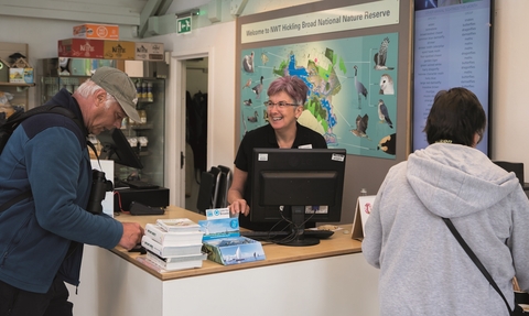 Staff and visitors at the till at Hickling visitor centre