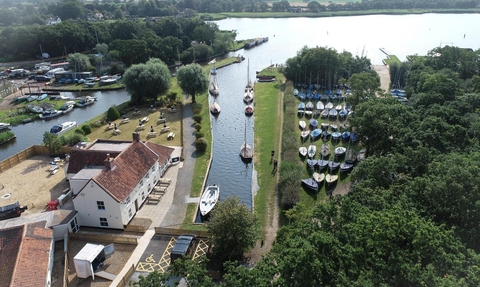 Aerial view of the Pleasure Boat Inn with views of Hickling Staithe and the wider broad