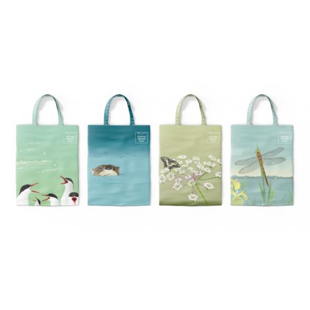 Four tote bags show four different patterns including a common tern, otter, swallowtail butterfly and Norfolk hawker dragonfly