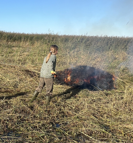 Kasper is helping burn grass at a reserve. 