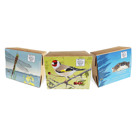 Three cardboard boxes containing bars of soap. Illustrated with a Norfolk hawker dragonfly, a goldfinch and an otter