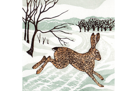 A linocut brown hare leaps over a snowy track framed by brown skeletal trees