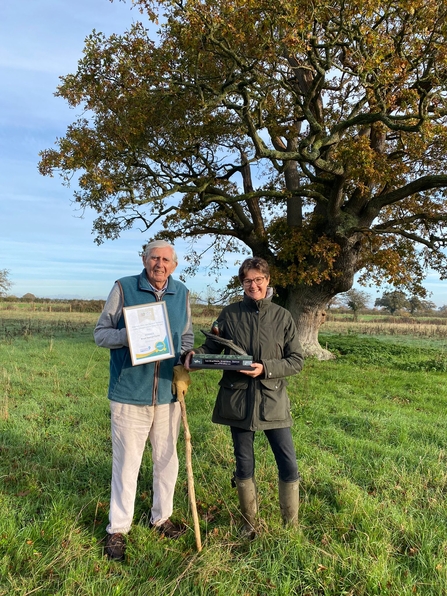 Louise Bond and her father Bruce Seaman with the trophy in one of the their meadows 